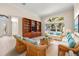 Inviting living room with comfortable seating, built-in shelving, and a bright window view at 4949 Sandy Brook Cir, Wimauma, FL 33598