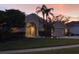 Two-story house with a three-car garage and lush landscaping at 6508 Steeplechase Dr, Tampa, FL 33625