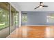 Living room with hardwood floors, ceiling fan, and sliding doors at 14458 Sterling Run, Spring Hill, FL 34609