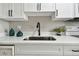 Modern kitchen features white shaker cabinets, quartz countertops, and stainless steel sink at 5095 Bay Ne St # 306, St Petersburg, FL 33703