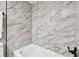 Updated bathroom featuring a tub and marble-style shower surround at 5095 Bay Ne St # 306, St Petersburg, FL 33703
