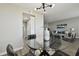 Dining area with glass top table, black chairs, and modern light fixture at 5095 Bay Ne St # 306, St Petersburg, FL 33703