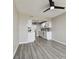 Living area with gray flooring, a ceiling fan, and kitchen view at 5095 Bay Ne St # 306, St Petersburg, FL 33703