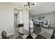 Dining area with glass top table, black chairs, and modern light fixture at 5095 Bay Ne St # 306, St Petersburg, FL 33703