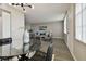 Dining area with glass top table, black chairs, and modern light fixture at 5095 Bay Ne St # 306, St Petersburg, FL 33703