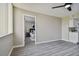 Open living room with gray flooring and view into bedroom at 5095 Bay Ne St # 306, St Petersburg, FL 33703