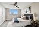 Bright bedroom with a queen-size bed, ceiling fan, and large window at 5095 Bay Ne St # 306, St Petersburg, FL 33703