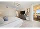 Bright bedroom with a king-size bed, a large TV, and access to a balcony at 1200 Gulf Blvd # 105, Clearwater Beach, FL 33767