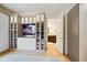 Large walk-in closet with custom shelving and a view into the bathroom at 1200 Gulf Blvd # 105, Clearwater Beach, FL 33767