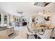 Open concept dining area with glass table, modern chairs, and artwork at 1200 Gulf Blvd # 105, Clearwater Beach, FL 33767