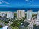 Aerial view of luxurious beachfront condo buildings and resort amenities at 1200 Gulf Blvd # 105, Clearwater Beach, FL 33767