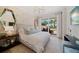 Serene bedroom with a king-size bed, and access to a private balcony at 1200 Gulf Blvd # 105, Clearwater Beach, FL 33767