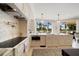 Bright kitchen with marble countertops, herringbone backsplash, and high-end appliances at 1200 Gulf Blvd # 105, Clearwater Beach, FL 33767