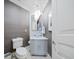 Stylish powder room featuring a modern sink and gray wallpaper at 1200 Gulf Blvd # 105, Clearwater Beach, FL 33767
