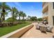 Expansive patio with dining furniture and lush landscaping at 1200 Gulf Blvd # 105, Clearwater Beach, FL 33767