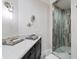 Elegant bathroom with marble vanity, designer wallpaper, and a spacious glass shower at 1200 Gulf Blvd # 105, Clearwater Beach, FL 33767