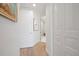 Bright hallway with hardwood floors and white doors at 1200 Gulf Blvd # 105, Clearwater Beach, FL 33767