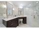 Spa-like bathroom with double sinks, a walk-in shower, and marble finishes at 1200 Gulf Blvd # 105, Clearwater Beach, FL 33767