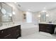 Elegant bathroom with double vanities, a large soaking tub, and marble flooring at 1200 Gulf Blvd # 105, Clearwater Beach, FL 33767