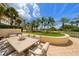 Outdoor dining patio with seating for six overlooking tropical landscape at 1200 Gulf Blvd # 105, Clearwater Beach, FL 33767