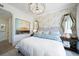 Elegant bedroom with large bed, decorative mirrors, and artwork at 1200 Gulf Blvd # 105, Clearwater Beach, FL 33767