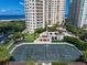 Aerial view of a well-maintained tennis court within a resort community at 1200 Gulf Blvd # 105, Clearwater Beach, FL 33767