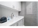 Modern laundry room with white cabinets and a convenient utility sink at 1200 Gulf Blvd # 105, Clearwater Beach, FL 33767