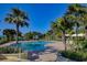 Inviting resort-style pool surrounded by palm trees at 1200 Gulf Blvd # 105, Clearwater Beach, FL 33767