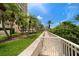 Lush landscaping lines a walkway leading through the community at 1200 Gulf Blvd # 105, Clearwater Beach, FL 33767