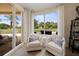 Cozy sitting area with comfortable armchairs and views of the patio and ocean at 1200 Gulf Blvd # 105, Clearwater Beach, FL 33767