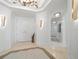 Grand entryway with high ceilings and modern chandelier at 1200 Gulf Blvd # 105, Clearwater Beach, FL 33767