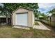 Tan storage shed with white door in backyard at 7051 Hibiscus S Ave, South Pasadena, FL 33707