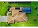 Bird's-eye view of home, showcasing roofline and pool enclosure at 13217 Thoroughbred Dr, Dade City, FL 33525
