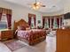Spacious Primary bedroom with wooden furniture and large windows at 13217 Thoroughbred Dr, Dade City, FL 33525