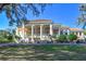 Elegant community clubhouse with columns and golf cart parking at 13217 Thoroughbred Dr, Dade City, FL 33525