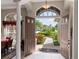 Elegant entryway with double doors opening to a view of the backyard and golf course at 13217 Thoroughbred Dr, Dade City, FL 33525