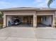 Spacious two-car garage with golf cart and storage shelving at 13217 Thoroughbred Dr, Dade City, FL 33525