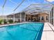 Inviting screened-in pool with patio furniture at 13217 Thoroughbred Dr, Dade City, FL 33525