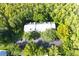 Aerial view of an apartment building with surrounding trees and parking at 1398 Shady Pine Way # H3, Tarpon Springs, FL 34688