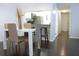 Modern dining area with white table, gold chairs, and kitchen bar at 1398 Shady Pine Way # H3, Tarpon Springs, FL 34688