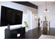 Living room with dark hardwood floors and large flat-screen TV at 1398 Shady Pine Way # H3, Tarpon Springs, FL 34688