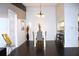 Elegant dining room with dark hardwood floors and modern chandelier at 1398 Shady Pine Way # H3, Tarpon Springs, FL 34688