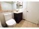 Bathroom features a toilet, vanity with a large mirror at 1398 Shady Pine Way # H3, Tarpon Springs, FL 34688