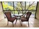 Private balcony with wicker furniture and treetop views at 1398 Shady Pine Way # H3, Tarpon Springs, FL 34688