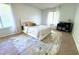 Spacious bedroom with a queen-size bed, carpet flooring, and a work area at 1398 Shady Pine Way # H3, Tarpon Springs, FL 34688