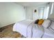 Bright bedroom with a queen-size bed and an area rug at 1398 Shady Pine Way # H3, Tarpon Springs, FL 34688