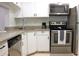 Modern kitchen with stainless steel appliances and granite countertops at 1398 Shady Pine Way # H3, Tarpon Springs, FL 34688
