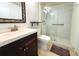 Bathroom with walk-in shower, toilet and dark brown vanity at 1398 Shady Pine Way # H3, Tarpon Springs, FL 34688