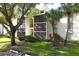 Two-story condo building with screened balconies and lush landscaping at 1398 Shady Pine Way # H3, Tarpon Springs, FL 34688