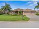 Two-story house with three-car garage and lush landscaping at 13217 Thoroughbred Dr, Dade City, FL 33525